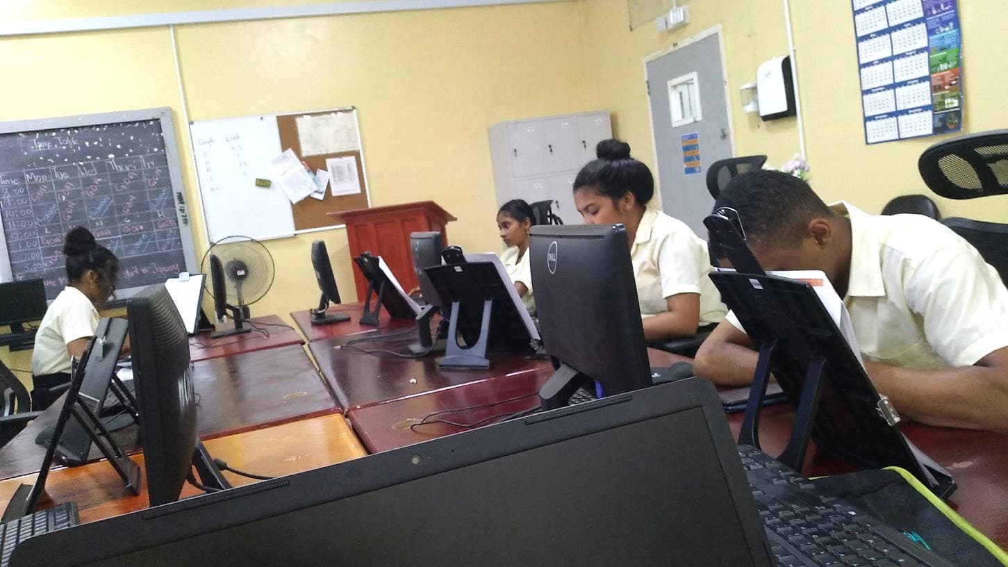 Learners working at computers in a training room