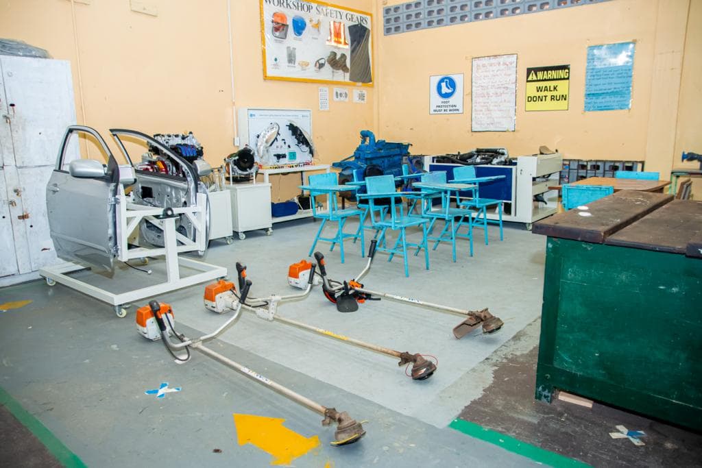 Workshop room with technical training equipment and line trimmers on the floor